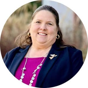 Cheryl Ringer, Hospice of the Piedmont CFO, wears a bright fuchsia blouse beneath a black suit