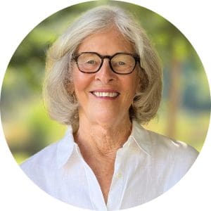 Bitsy Waters smiles wearing a white linen button down shirt